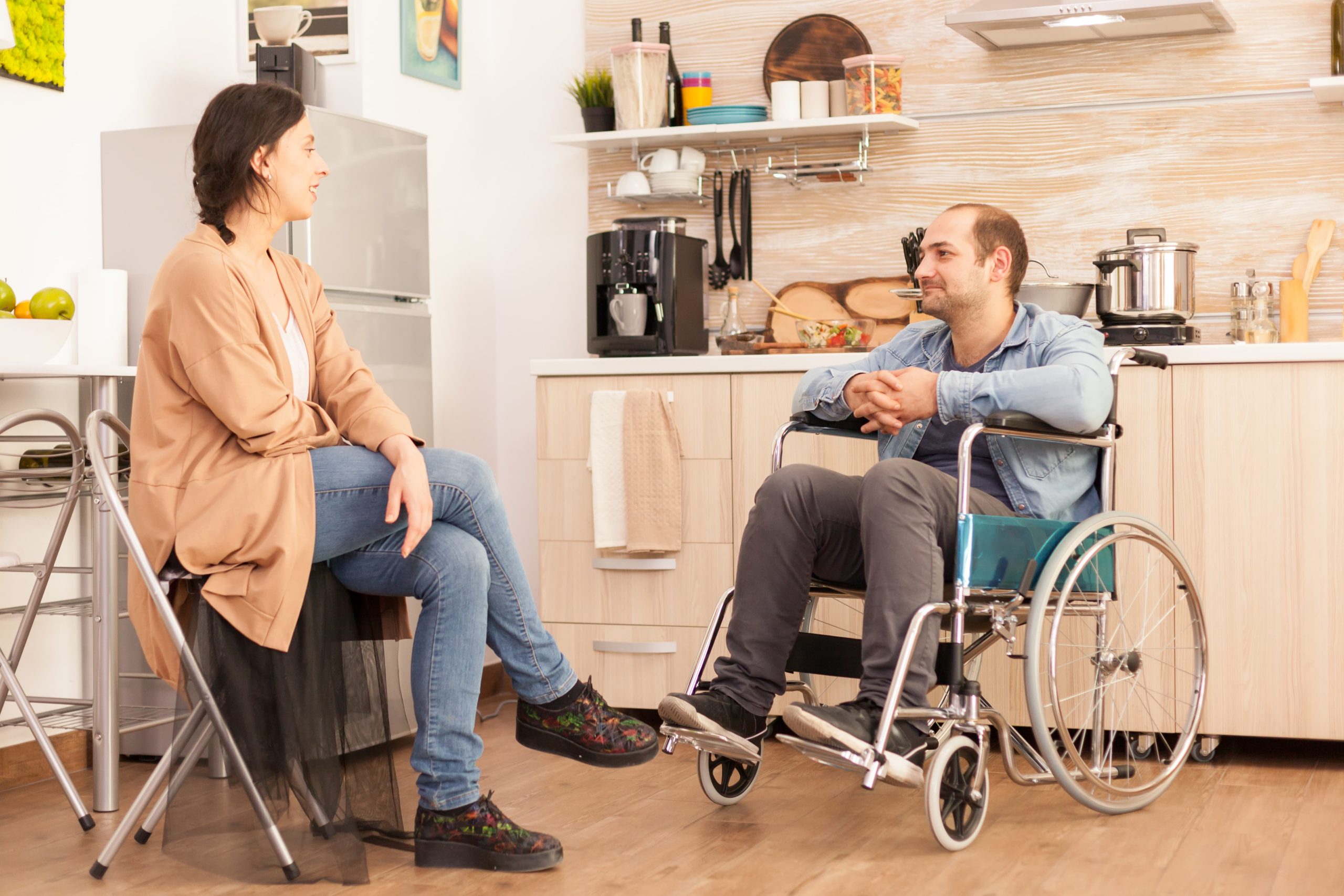 handicapped-man-wheelchair-looking-caring-wife-kitchen-disabled-paralyzed-handicapped-man-with-walking-disability-integrating-after-accident handicapped-man-wheelchair-looking-caring-wife-kitchen-disabled-paralyzed-handicapped-man-with-walking-disability-integrating-after-accident